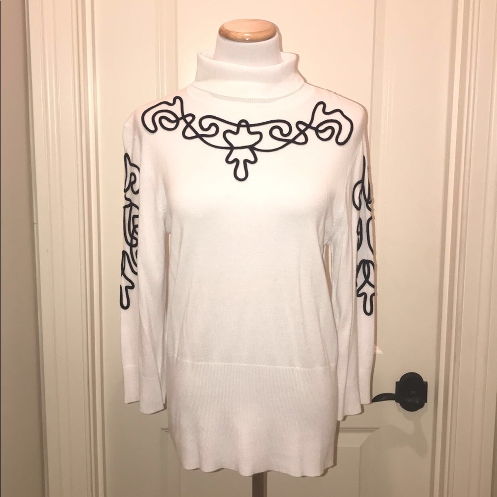 white sweater with black line design
